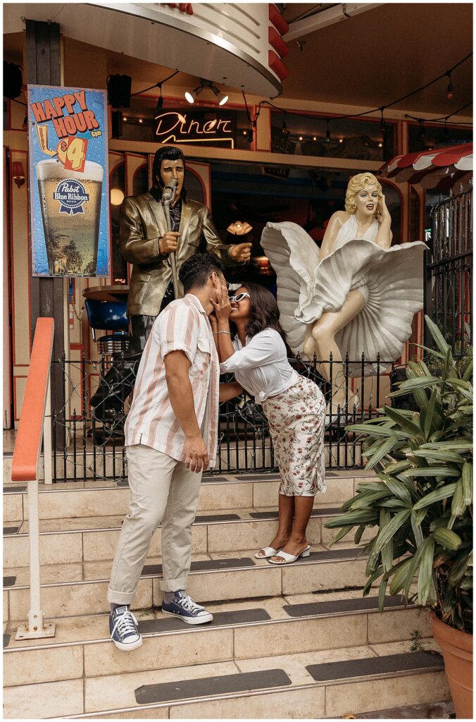 Man and woman kissing outside on stairs