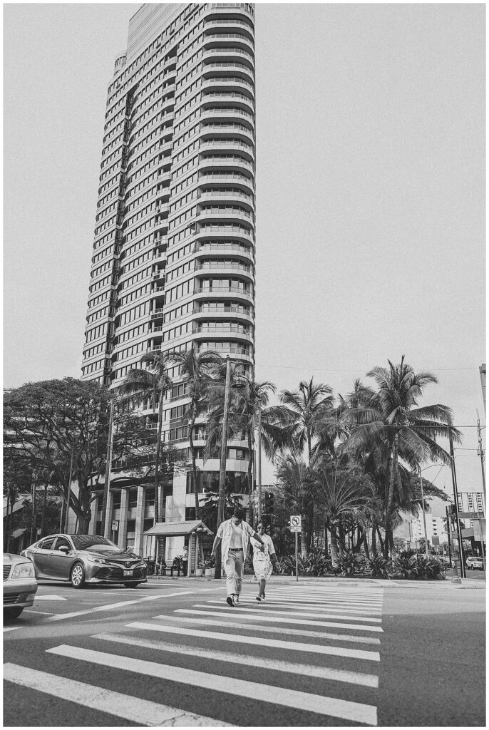 couples walking across cross walk downtown Honolulu, Hawaii