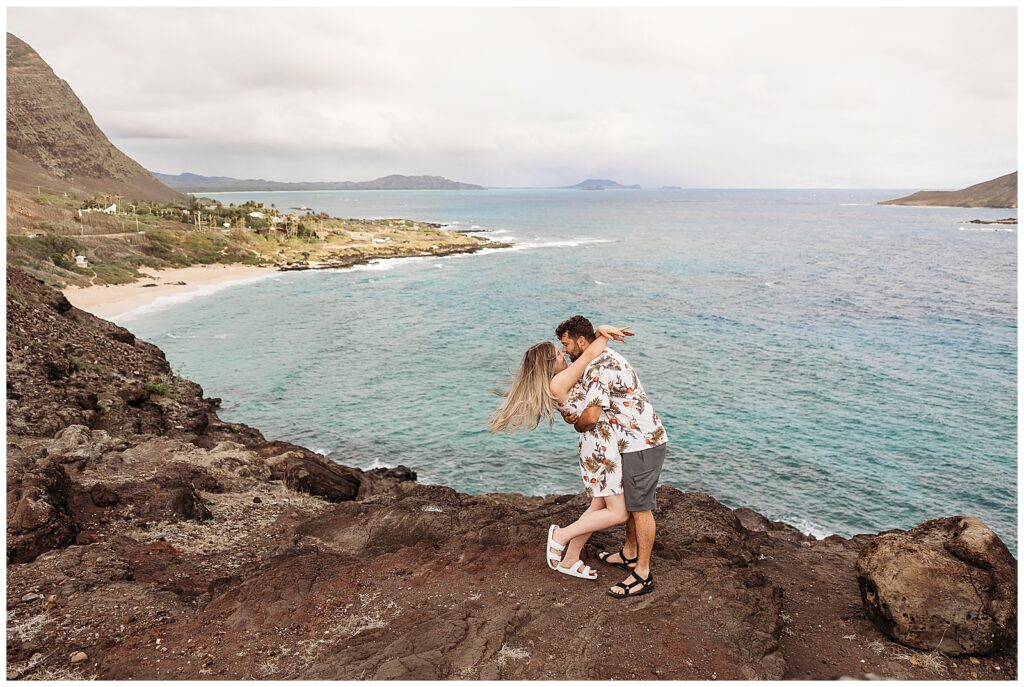 Couples standing on a cliff at makapuu beach lookout